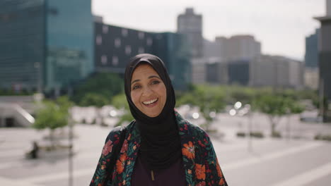 portrait-of-beautiful-mature-muslim-woman-laughing-cheerful-looking-at-camera-happy-enjoying-urban-city-lifestyle-wearing-traditional-hajib-headscarf