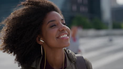 portrait-young-happy-african-american-woman-wearing-earphones-listening-to-music-dancing-enjoying-successful-urban-lifestyle-lively-black-female-student-afro-hairstyle-slow-motion