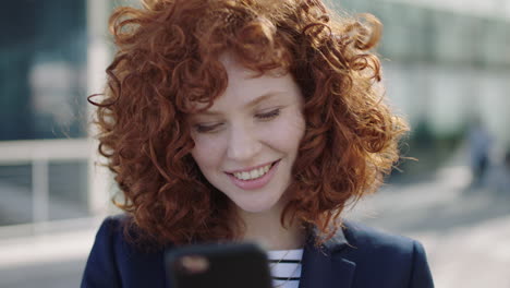 beautiful-young-business-woman-laughing-texting-on-phone-portrait-of-red-head-college-student-corporate