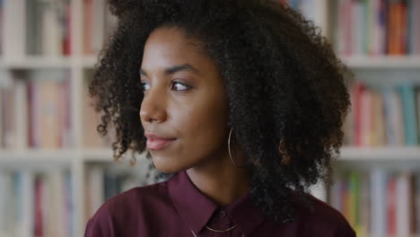 portrait-young-beautiful-african-american-woman-student-looking-pensive-turns-head-black-female-with-afro-hairstyle-slow-motion-bookshelf-background