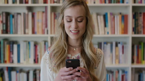 portrait-young-beautiful-blonde-woman-student-using-smartphone-enjoying-browsing-online-reading-messages-on-mobile-phone-app-cute-happy-female-in-library