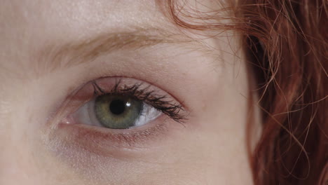 close-up-woman-beautiful-blue-eye-opening-looking-at-camera-blinking-red-head-female-eyesight-beauty