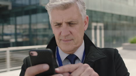 close-up-portrait-of-successful-businessman-browsing-messages-texting-using-smartphone-networking-happy-enjoying-mobile-technology