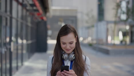 portrait-young-beautiful-business-woman-using-smartphone-in-city-enjoying-browsing-online-messages-texting-on-mobile-smiling-satisfaction-urban-outdoors-slow-motion