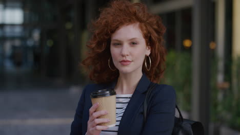 portrait-young-beautiful-red-head-business-woman-enjoying-successful-lifestyle-holding-coffee-wind-blowing-hair-in-urban-outdoors-background-ambition-success
