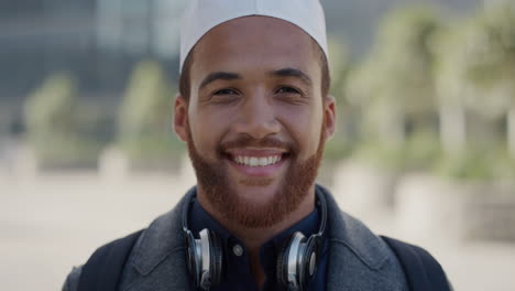 portrait-young-happy-entrepreneur-man-smiling-enjoying-successful-urban-lifestyle-friendly-muslim-businessman-wearing-kufi-hat-in-sunny-urban-city-slow-motion