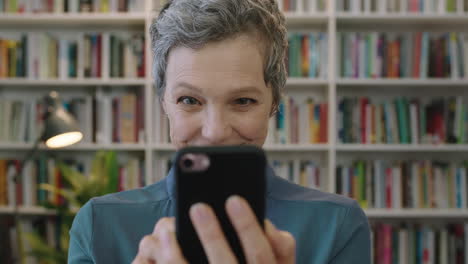 portrait-of-mature-friendly-caucasian-woman-librarian-texting-browsing-using-smartphone-social-media-app-reading-text-message-surprised-expression