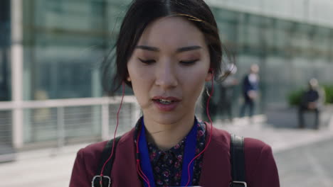 young-asian-woman-portrait-listening-to-music-with-earphones-student-on-campus-student-education-corporate