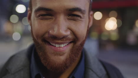 close-up-portrait-of-young-mixed-race-man-smiling-cheerful-at-camera-enjoying-urban-evening-commuting-in-city