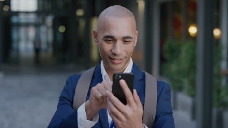 portrait-young-hispanic-entrepreneur-man-using-smartphone-in-city-enjoying-texting-browsing-messages-on-mobile-phone-communicating-online-slow-motion-digital-communication