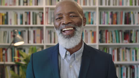 close-up-portrait-of-senior-african-american-businessman-with-beard-laughing-happy-enjoying-successful-career-milestone-professional-mature-black-male-wearing-suit-in-library