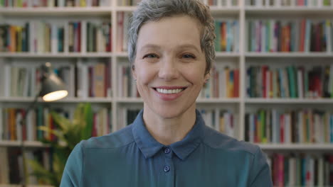 portrait-of-mature-friendly-caucasian-woman-librarian-smiling-happy-enjoying-career-education-milestone-cheerful-middle-aged-female-in-library-background