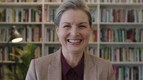 close-up-portrait-of-happy-senior-business-woman-executive-smiling-enjoying-successful-corporate-career-in-bookshelf-background