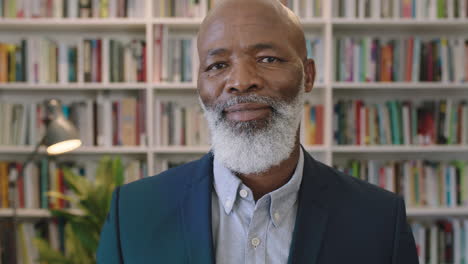 close-up-portrait-of-middle-aged-african-american-businessman-with-beard-laughing-happy-enjoying-successful-career-milestone-professional-mature-black-male-wearing-suit-in-library