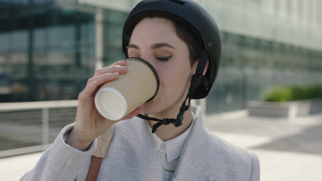 close-up-portrait-of-beautiful-young-business-woman-intern-wearing-safety-helmet-drinking-coffee-ready-to-leave-work