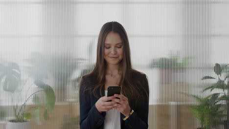 portrait-young-successful-business-woman-executive-using-smartphone-enjoying-texting-browsing-online-messages-sending-email-sms-on-mobile-phone-in-office