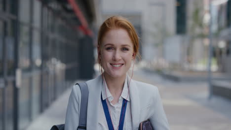 portrait-independent-young-business-woman-smiling-wearing-earphones-enjoying-relaxed-urban-lifestyle-listening-to-music-in-city-slow-motion-successful-female