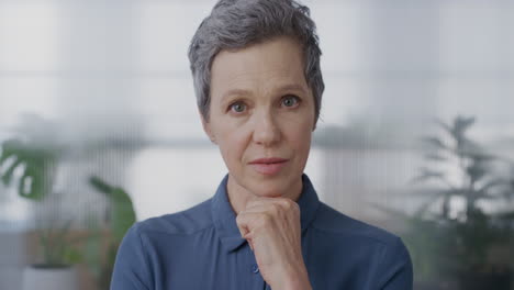 portrait-professional-senior-business-woman-looking-pensive-at-camera-contemplative-middle-aged-entrepreneur-thinking-in-office-background-slow-motion