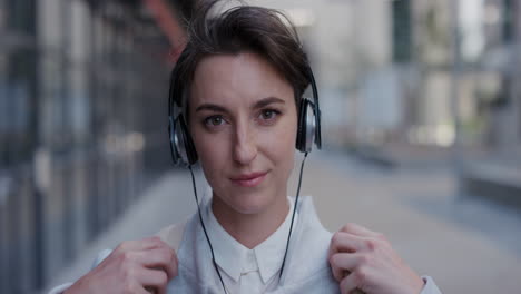 portrait-young-beautiful-business-woman-wearing-earphones-enjoying-listening-to-music-in-city-relaxing-slow-motion