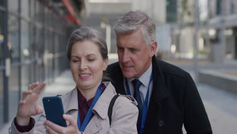 portrait-happy-senior-caucasian-couple-using-smartphone-taking-selfie-photos-posing-enjoying-making-faces-having-fun-together-in-city-slow-motion