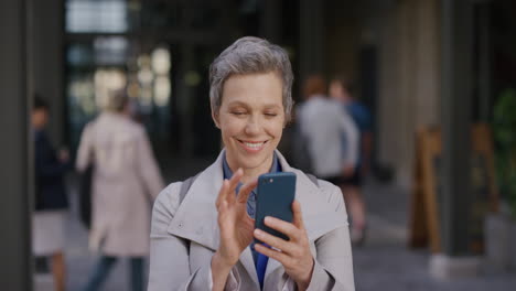 portrait-independent-middle-aged-business-woman-using-smartphone-in-city-enjoying-browsing-online-messages-texting-on-mobile-phone-slow-motion