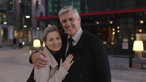 portrait-of-senior-stylish-couple-meeting-in-city-embracing-enjoying-urban-evening-together-smiling-happy