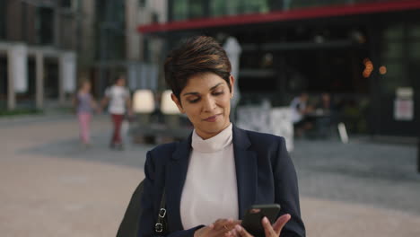 portrait-of-professional-business-woman-using-smartphone-mobile-technology-smiling-checking-messages-browsing-networking
