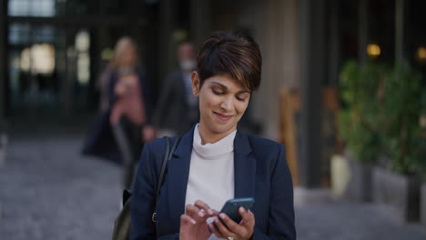 portrait-successful-young-business-woman-executive-using-smartphone-in-city-enjoying-realxed-urban-lifestyle-texting-on-mobile-phone-slow-motion