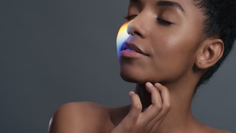 multicolor-portrait-beautiful-african-american-woman-touching-shoulders-caressing-bare-skin-enjoying-skincare-beauty-with-colorful-light-reflecting-on-smooth-perfect-complexion