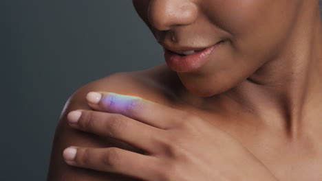 close-up-multicolor-portrait-beautiful-african-american-woman-touching-shoulders-caressing-bare-skin-enjoying-skincare-beauty-with-colorful-light-reflecting-on-smooth-complexion