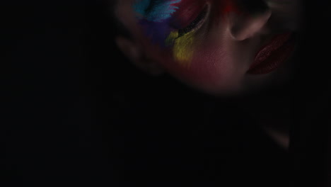 close-up-portrait-beautiful-woman-wearing-colorful-face-paint-dancing-exotic-multicolored-body-art-with-light-flashing-in-dark-fantasy