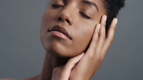 Nahaufnahme-Eines-Porträts-Einer-Schönen-Afroamerikanerin,-Die-Sanft-Ihr-Gesicht-Mit-Den-Händen-Berührt-Und-Einen-Glatten,-Gesunden-Teint-Genießt.-Natürliches,-Feminines-Schönheits-Hautpflegekonzept