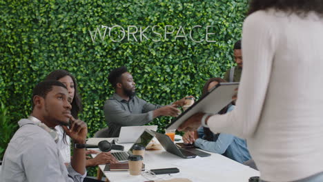 african-american-business-people-meeting-pregnant-team-leader-woman-using-tablet-computer-presenting-mobile-application-design-sharing-creative-ideas-for-communication-app-in-office-presentation