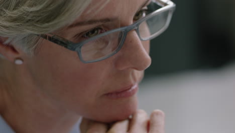 middle-aged-business-woman-manager-talking-to-colleague-sharing-ideas-collaborating-on-creative-project-smiling-enjoying-teamwork-conversation-in-successful-office-meeting-wearing-glasses-close-up