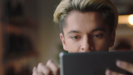 close-up-attractive-young-hispanic-man-student-using-tablet-computer-in-cafe-browsing-online-reading-social-media-messages-enjoying-sharing-relaxing-lifestyle