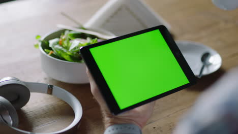businesman-using-tablet-computer-in-cafe-watching-green-screen-on-mobile-device-chroma-key-enjoying-online-entertainment-drinking-coffee-reading-social-media-advertising-close-up-hands