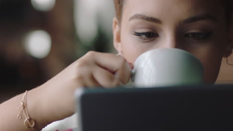 close-up-beautiful-young-mixed-race-woman-student-using-tablet-computer-in-cafe-drinking-coffee-browsing-online-reading-social-media-messages-enjoying-sharing-relaxing-lifestyle