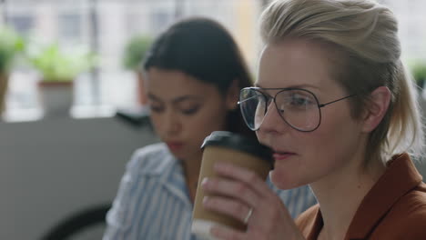 professional-caucasian-business-woman-drinking-coffee-beautiful-female-office-manager-listening-to-discussion-wearing-glasses-in-modern-startup-workplace-meeting
