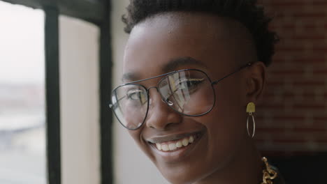 close-up-portrait-stylish-young-african-american-woman-student-smiling-happy-enjoying-successful-lifestyle-wearing-trendy-fashion-glasses-looking-out-window-in-modern-apartment-loft