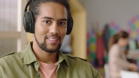 close-up-portrait-young-mixed-race-man-using-laptop-computer-browsing-online-messages-sharing-network-communication-student-drinking-coffee-enjoying-listening-to-music-in-modern-office