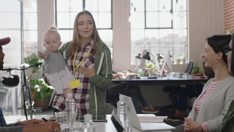 business-people-meeting-team-leader-mother-holding-baby-talking-to-colleagues-discussing-corporate-project-multitasking-in-modern-office-workplace