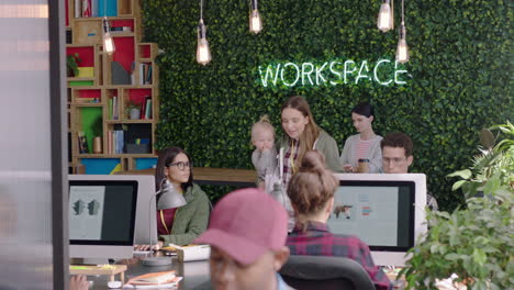 happy-business-woman-mother-holding-baby-office-manager-checking-on-colleagues-sharing-ideas-discussing-work-in-diverse-modern-office-workplace
