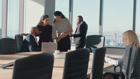 business-woman-team-leader-discussing-project-helping-colleagues-using-laptop-computer-brainstorming-ideas-in-office-boardroom