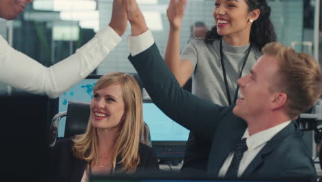 sales-team-celebrating-success-with-high-five-looking-at-financial-graph-data-on-computer-screen-happy-business-people-enjoying-corporate-victory-achievement-in-office