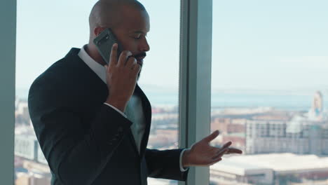 confident-businessman-using-smartphone-talking-to-client-corporate-executive-negotiating-business-deal-company-ceo-having-phone-call-in-office-looking-out-window