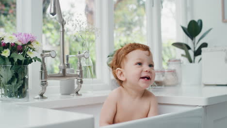 happy-baby-bathing-funny-toddler-taking-bath-in-kitchen-sink-having-fun-with-soap-bubbles-4k