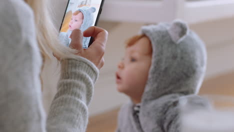 mother-taking-photo-of-baby-using-smartphone-enjoying-photographing-cute-toddler-sharing-motherhood-lifestyle-on-social-media
