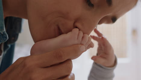 close-up-mother-kissing-baby's-feet-playfully-nurturing-newborn-caring-for-infant-enjoying-motherhood-connection-with-child