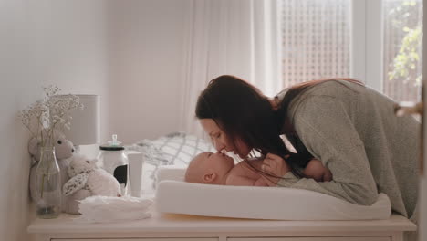 happy-mother-gently-kissing-baby-enjoying-loving-mom-playfully-caring-for-toddler-on-changing-table-at-home-sharing-connection-with-her-newborn-child-healthy-childcare