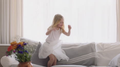 beautiful-little-girl-jumping-on-sofa-dancing-having-fun-child-in-playful-mood-enjoying-weekend-morning-at-home